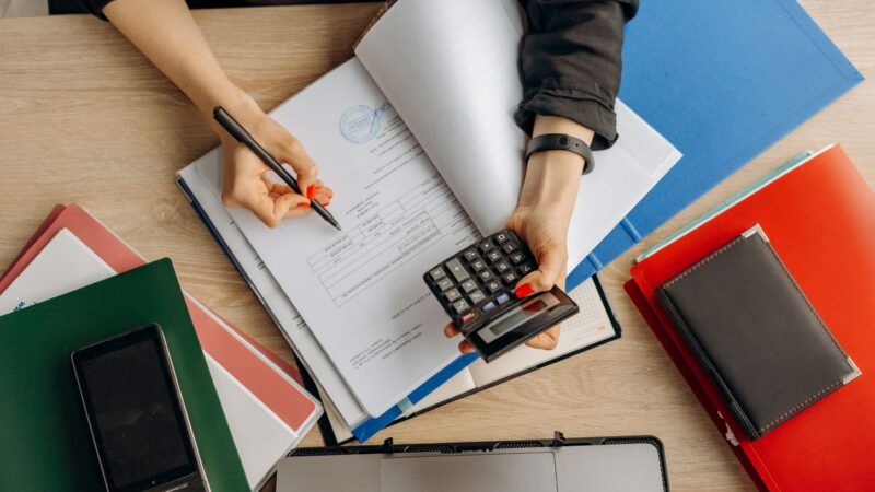 Business documents and calculator on a desk, illustrating tax code status 03 and 06 in Vietnam